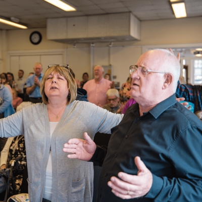 People with eyes closed in worship